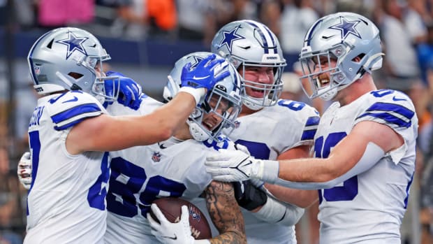 Cowboys tight end Peyton Hendershot celebrates with teammates after scoring a touchdown.